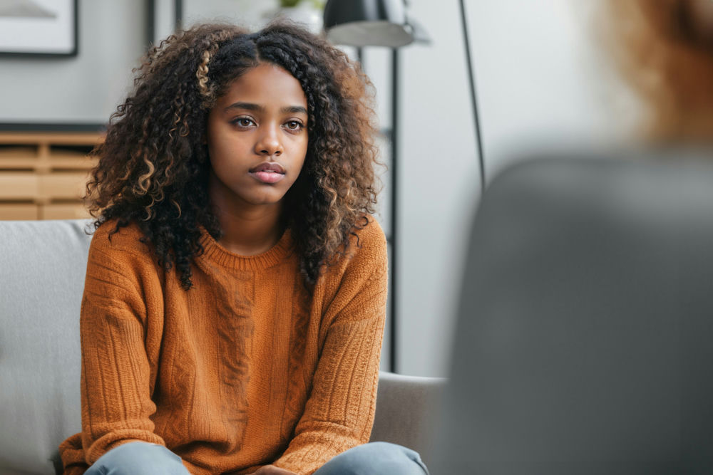 a teen girl staring at her therapist